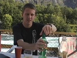 Julian makes the most of the finest hostel of the tour with an iced drink by the river